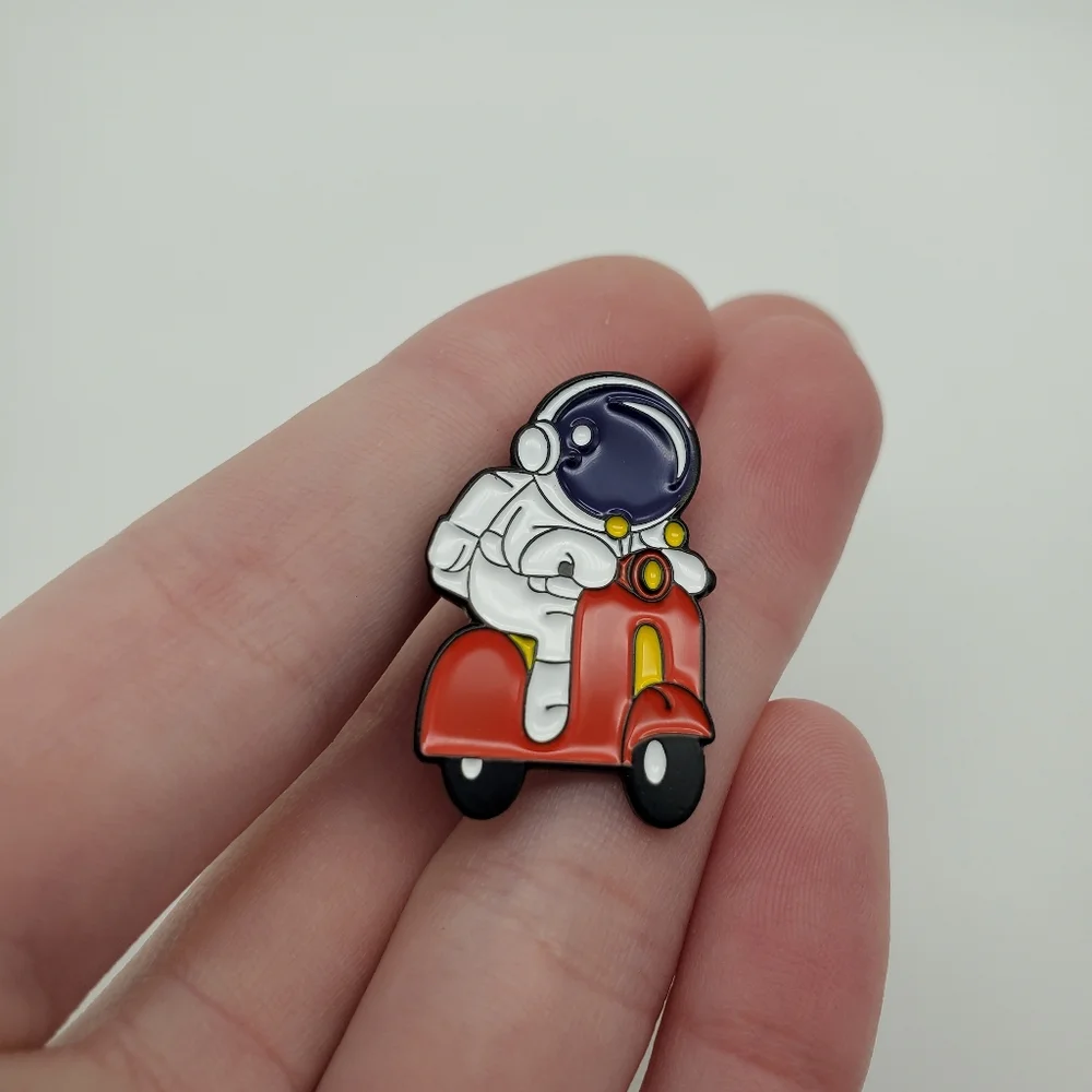 Astronaut on a bike pin